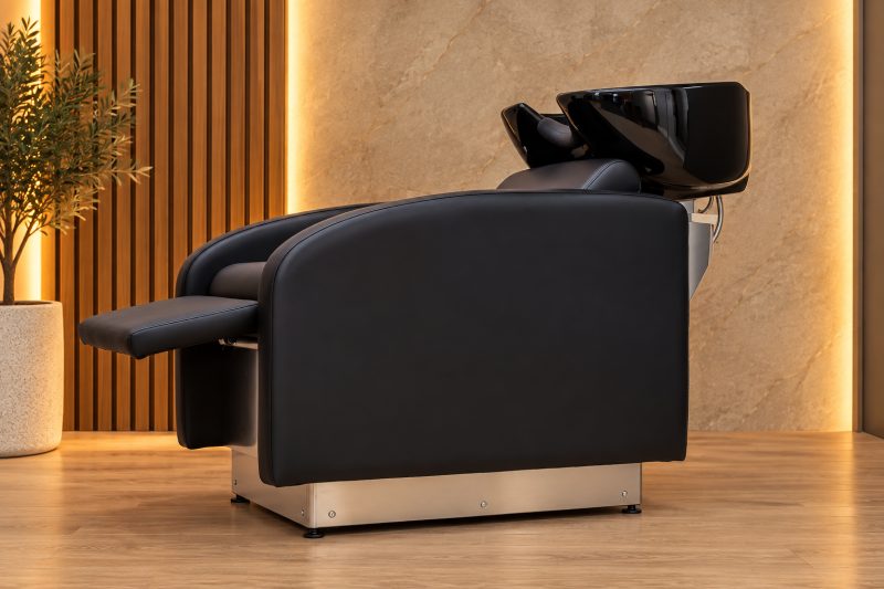 Bac LIBI LIFT vu de profil dans un salon, socle inox sorti en position haute, repose-jambes replié.